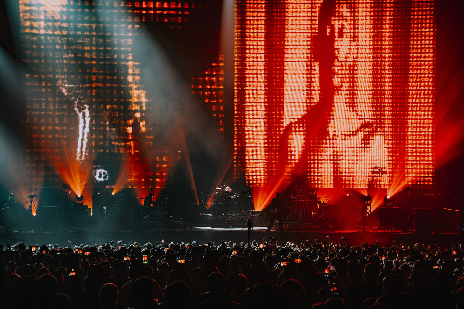 Video portrait on the LED wall with orange beams, Faithless at Creamfields 2026