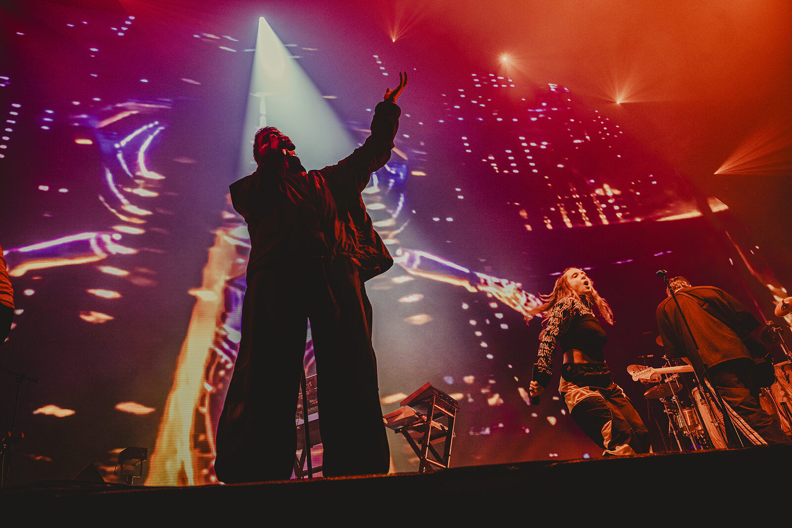 Singer with arm raised under a purple spotlight, Faithless at Creamfields 2026