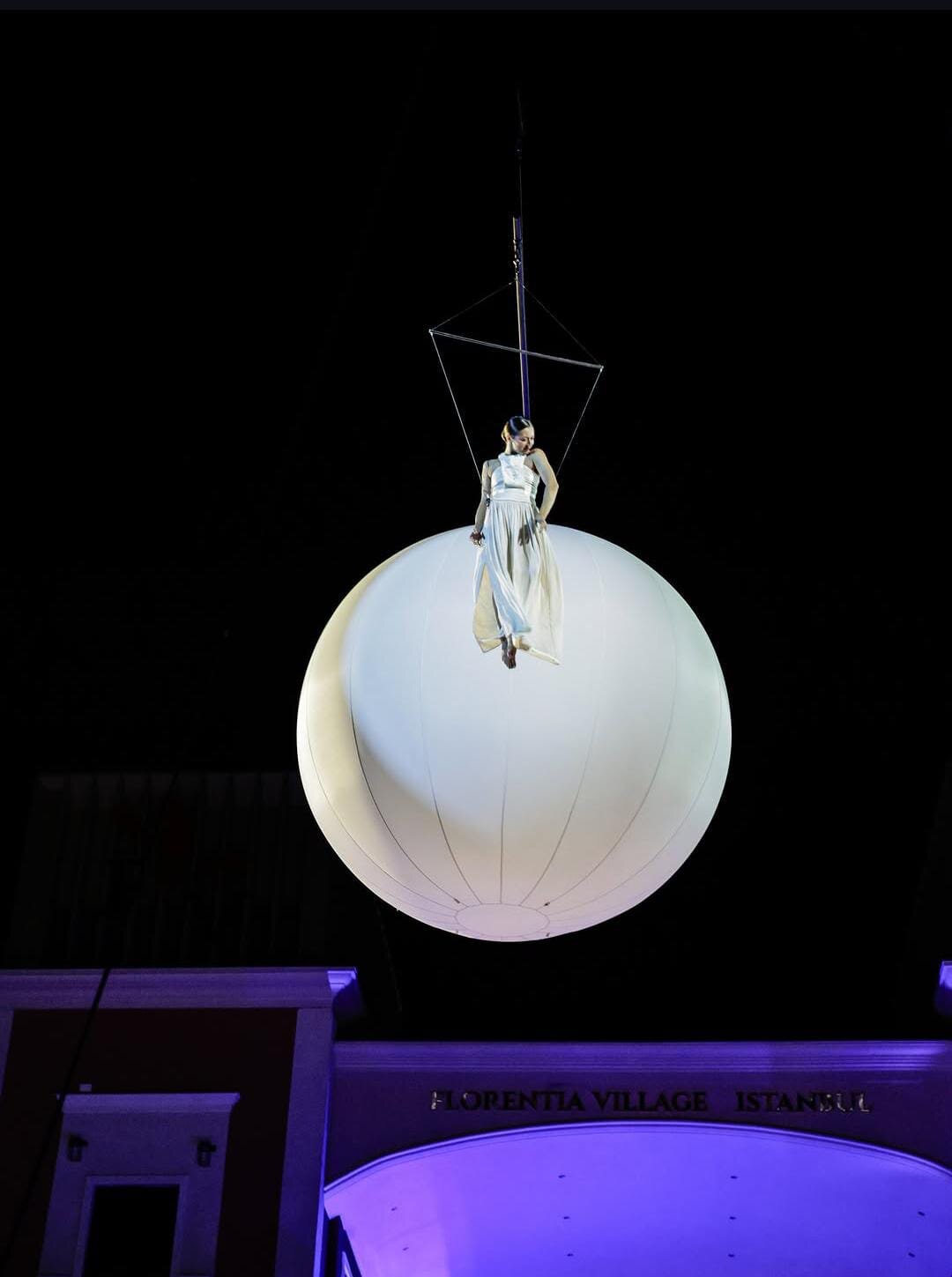 Aerialist on a white sphere