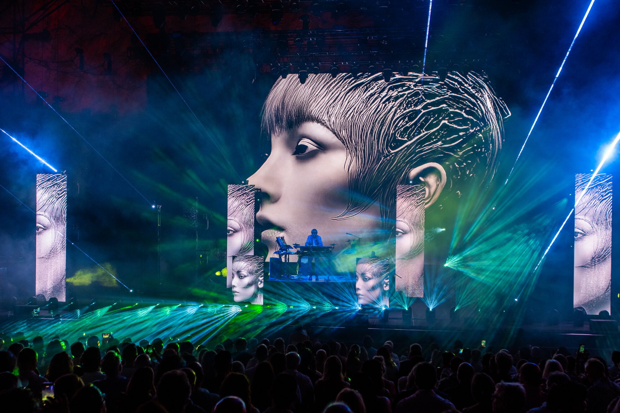 Portrait video on the central screen with laser fans